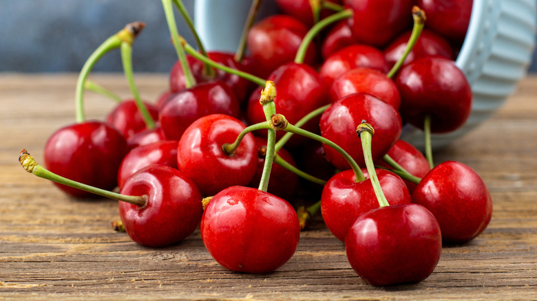 cherries spilling from white bowl