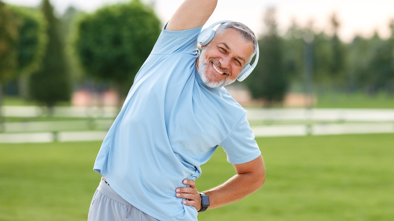 smiling man warming up outdoors