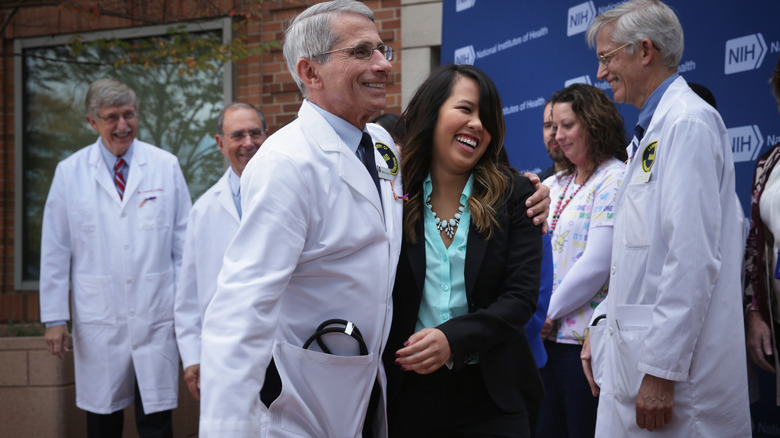 Fauci smiling with recovered Ebola patient at press event