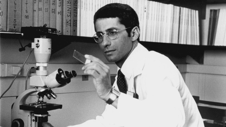 Anthony Fauci working at a microscope