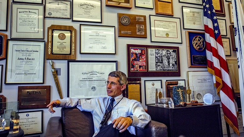 Anthony Fauci seated in office with framed diplomas