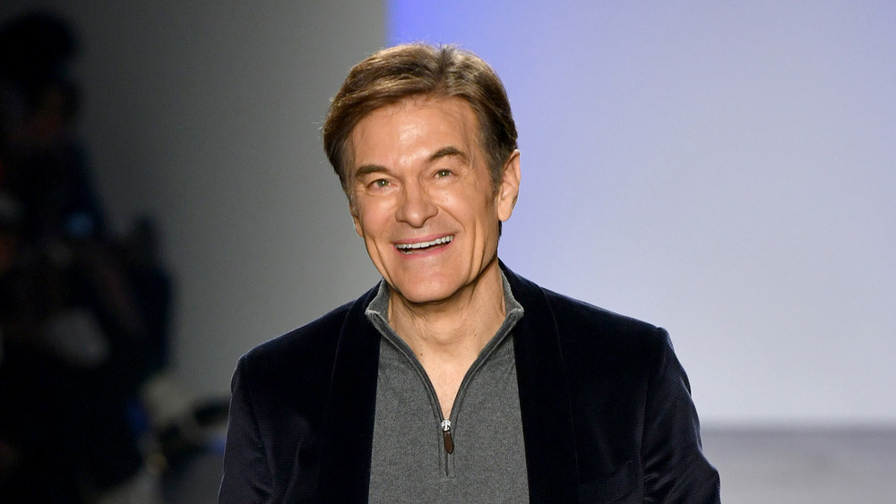 Dr Oz smiling and walking
