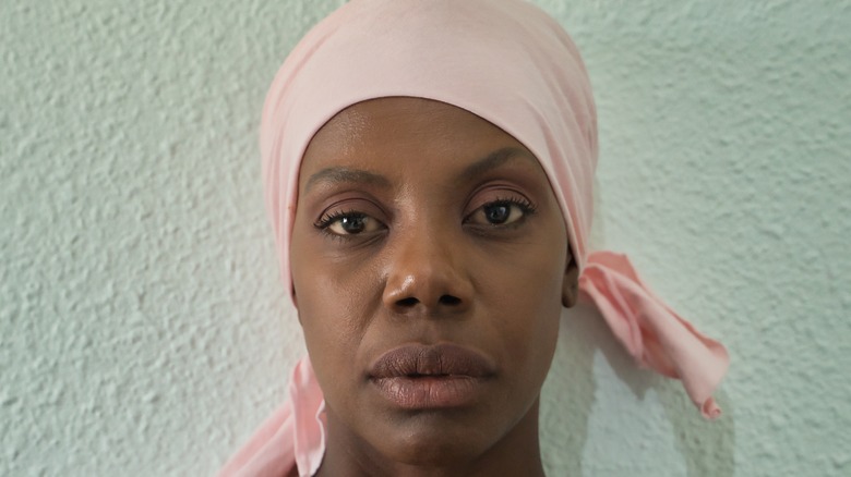 African American woman with pink head scarf