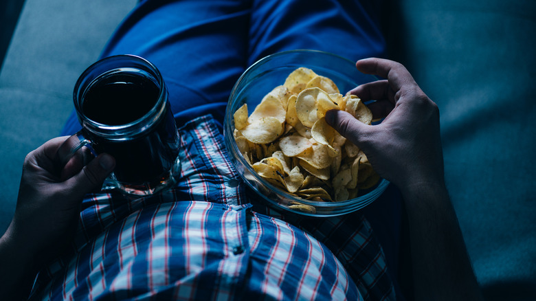 Man on couch with junk food