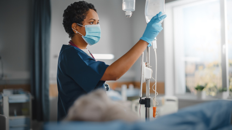 A doctor prepares an IV drip