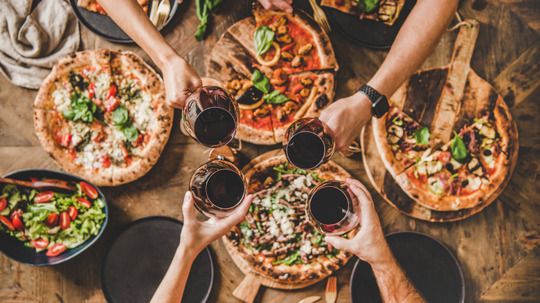 friends enjoying pizza and wine