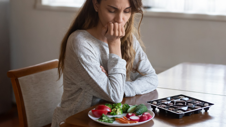 woman nervously looking at food