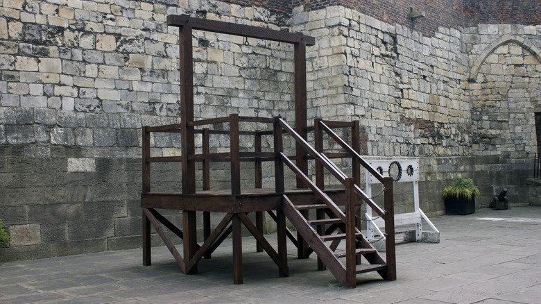 gallows outside a castle structure