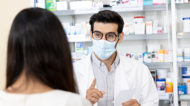 Pharmacist consults with a customer