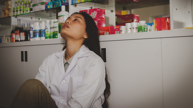 a female pharmacist looking pensive