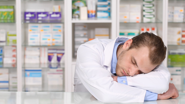 Exhausted pharmacist sleeps