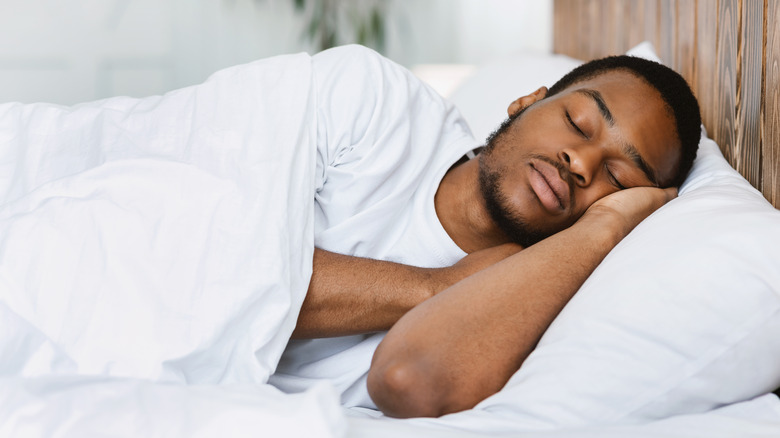 adult man sleeping in bed