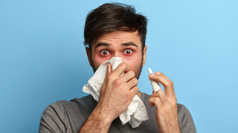 man using nasal spray