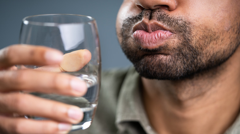 man gargling water