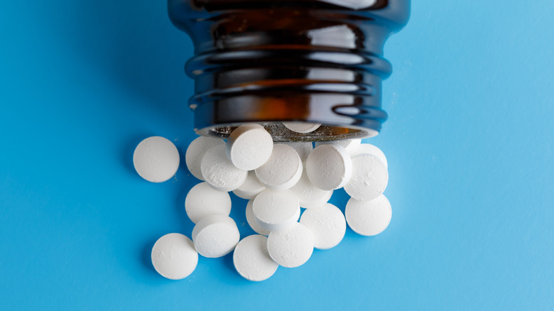 Zinc supplements spilling out of a bottle