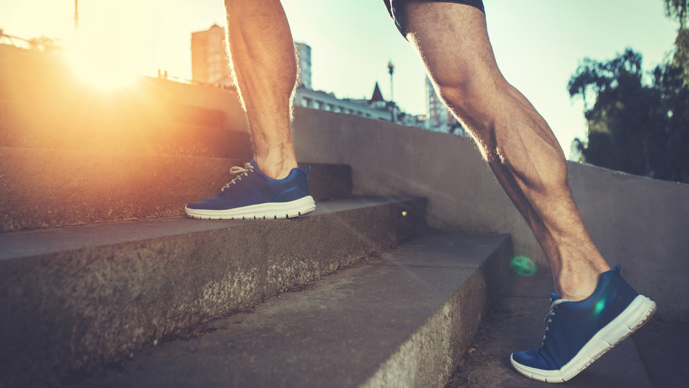 Strong male calves walking up stairs 