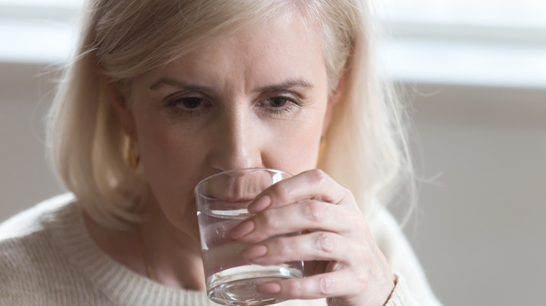 Older woman drinking water