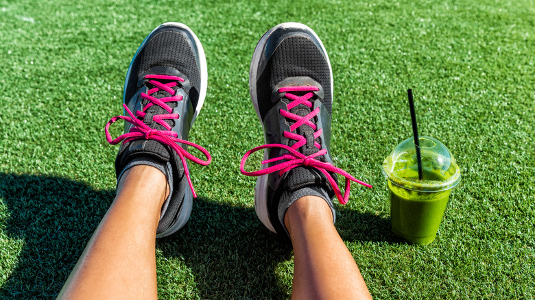 man after workout with green smoothie