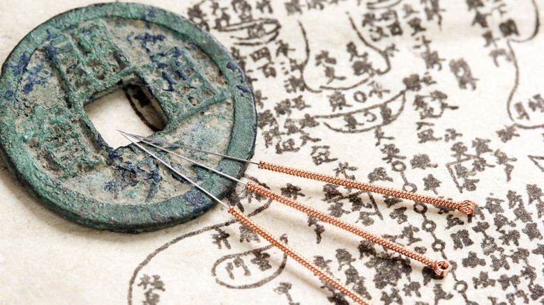 acupuncture needles and map
