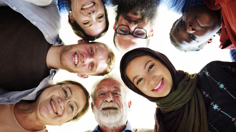 people of different nationalities and ages looking down at camera