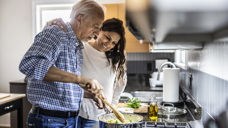 over-50 couple cooking healthy meal