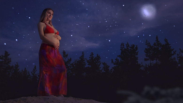 pregnant woman at night under the moon