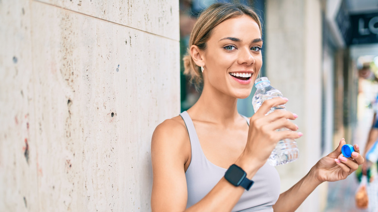 Woman drinking from water bottle