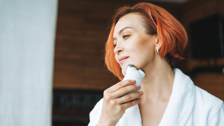 Woman holding device to her chin