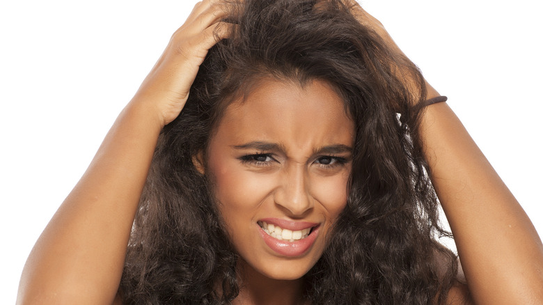 a young woman stressed with her hands on her head