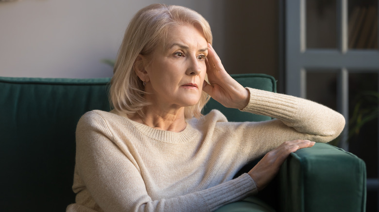 Worried woman on couch