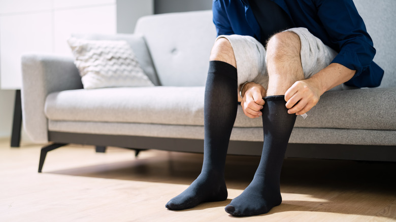 Man wearing compression stockings for deep vein thrombosis