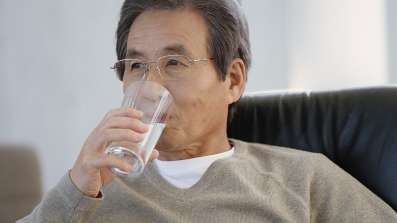 elderly man drinking water