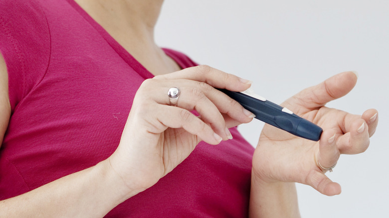diabetic woman testing finger