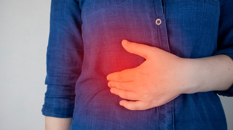 woman holding painful liver