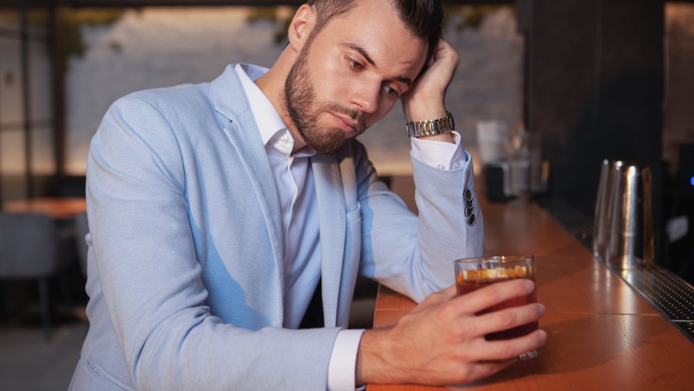 Young man drinking whiskey