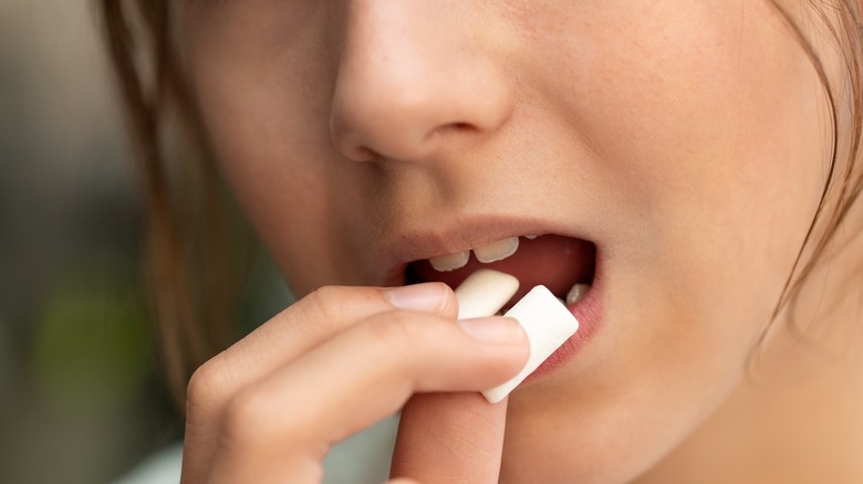 woman chewing stick of gum