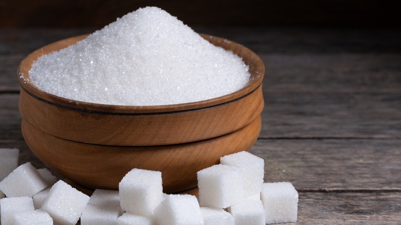 bowl of sugar next to sugar cubes