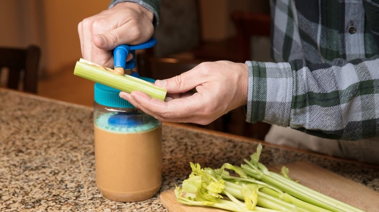 Hand using peanut butter pump