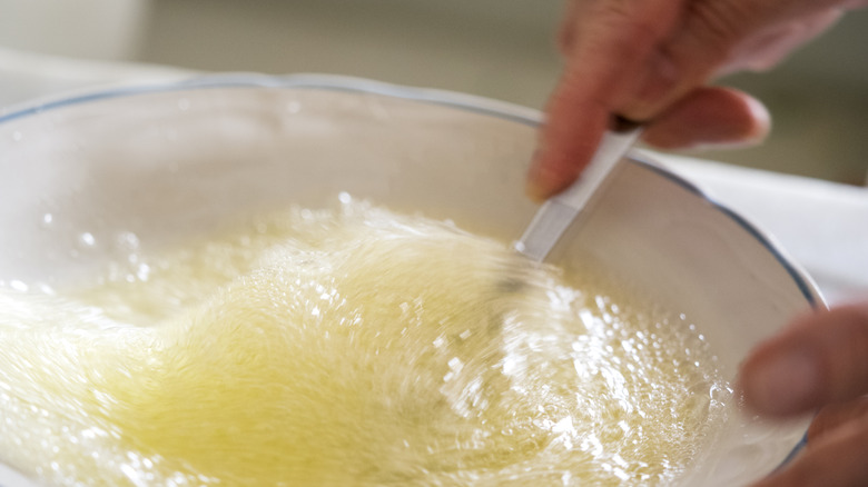 man's hand stirring egg whites