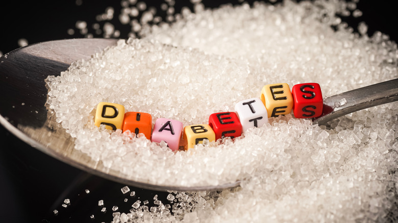 The word diabetes spelled out on a spoon of sugar