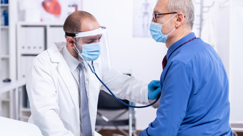 doctor listening to patient's heart