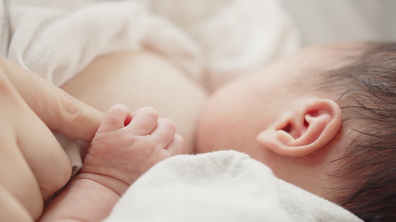 closeup of an infant breastfeeing 