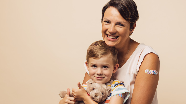 Mom and son with bandages on upper arms