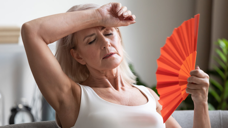 Woman fanning herself 