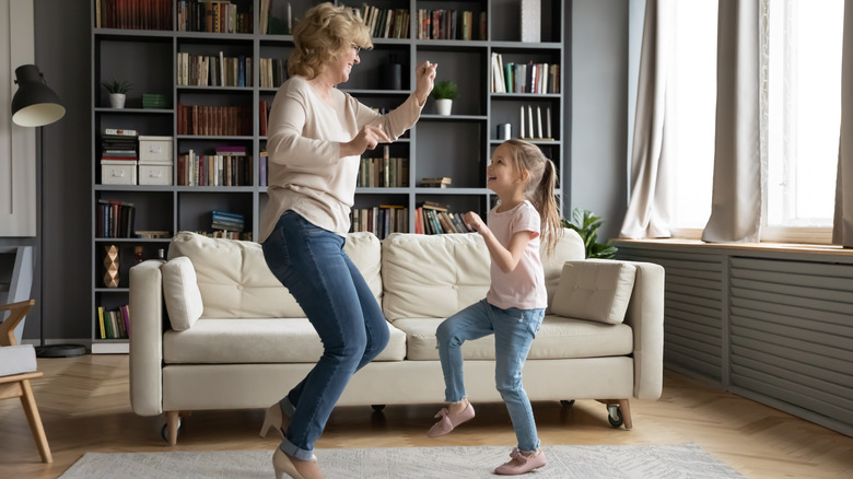 a grandma and granddaughter dancing together 