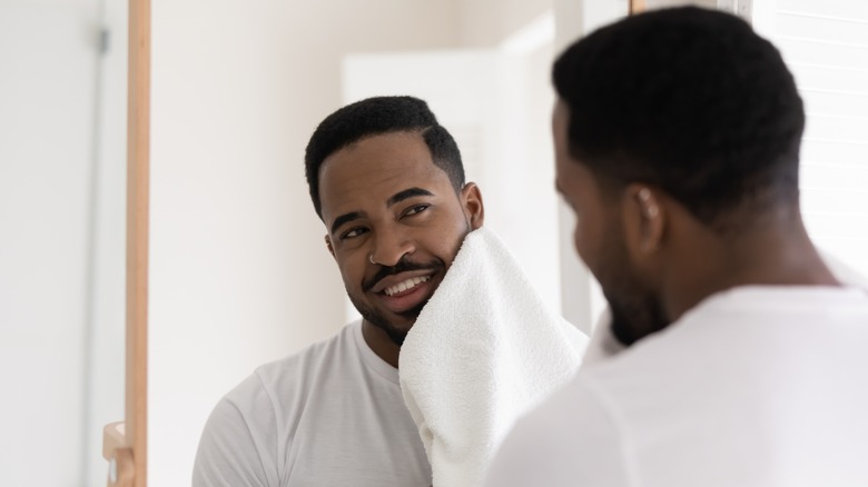 man using towel on face