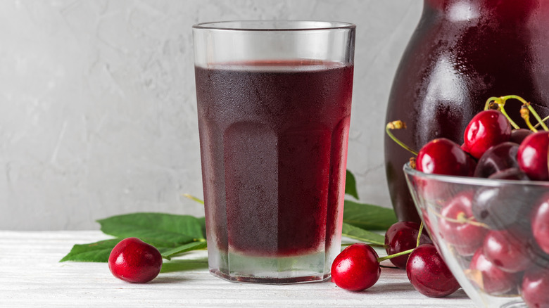 glass of tart cherry juice with cherries