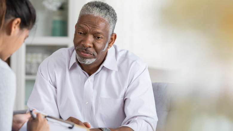 Man sitting with mental health counselor