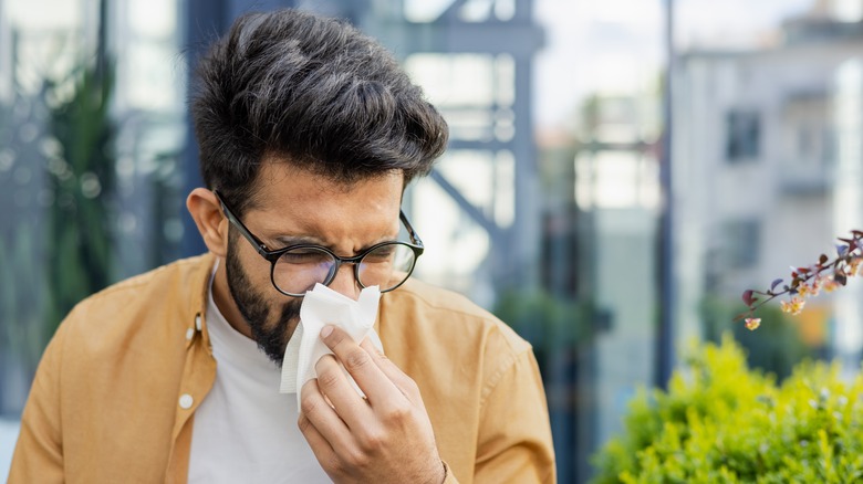 Man blowing his nose