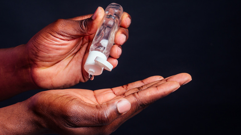 close up of man's hand using lube